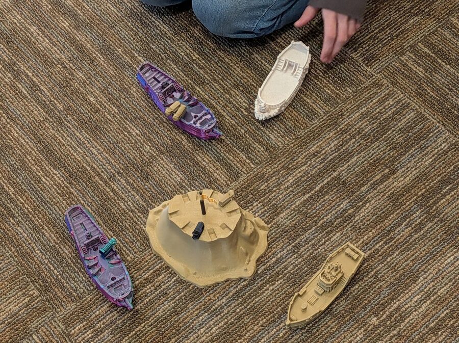 Four ships arranged around a central sandstone island for playtesting.